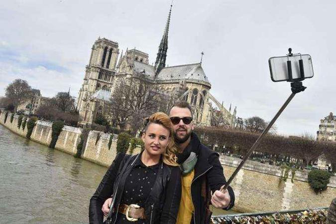 Turistas fazem selfie próximos à Catedral de Notre Dame, em Paris(foto: AFP PHOTO / DOMINIQUE FAGET) Turistas fazem selfie próximos à Catedral de Notre Dame, em Paris(foto: AFP PHOTO / DOMINIQUE FAGET)