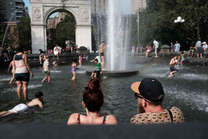 Pessoas se refrescam na fonte da Washington Square Park, no Estados Unidos(foto: Spencer Platt/ GETTY IMAGES NORTH AMERICA / AFP) Pessoas se refrescam na fonte da Washington Square Park, no Estados Unidos(foto: Spencer Platt/ GETTY IMAGES NORTH AMERICA / AFP)