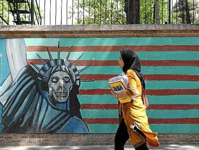 Moradora de Teerã caminha diante de grafite com referência à Estátua da Liberdade, em muro da Embaixada dos Estados Unidos: tensão crescente(foto: Atta Kenre/AFP) Moradora de Teerã caminha diante de grafite com referência à Estátua da Liberdade, em muro da Embaixada dos Estados Unidos: tensão crescente(foto: Atta Kenre/AFP)
