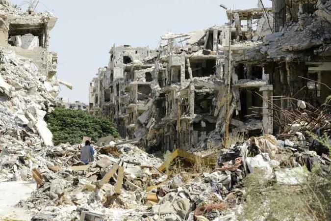 Foto mostra prédios destruídos na cidade de Homs, na Síria, em 19 de setembro de 2016(foto: Louai Beshara/AFP/Arquivos ) Foto mostra prédios destruídos na cidade de Homs, na Síria, em 19 de setembro de 2016(foto: Louai Beshara/AFP/Arquivos )
