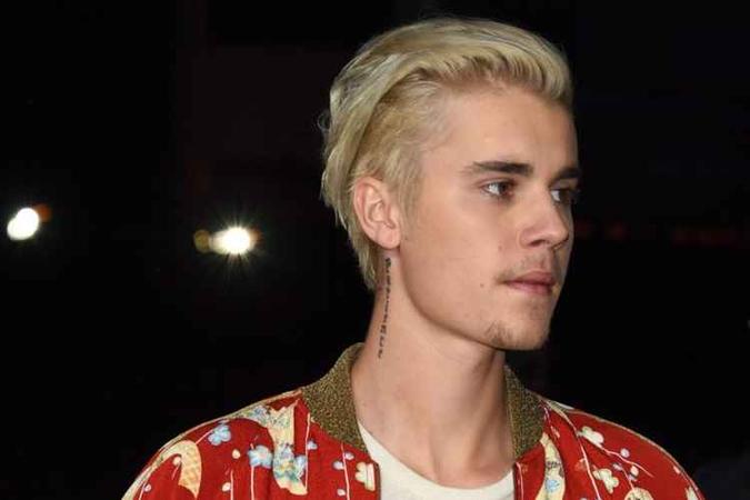 Cantor é fã assumido das tatuagens e anda com o corpo quase coberto por elas(foto: AFP / ROBYN BECK) Cantor é fã assumido das tatuagens e anda com o corpo quase coberto por elas(foto: AFP / ROBYN BECK)