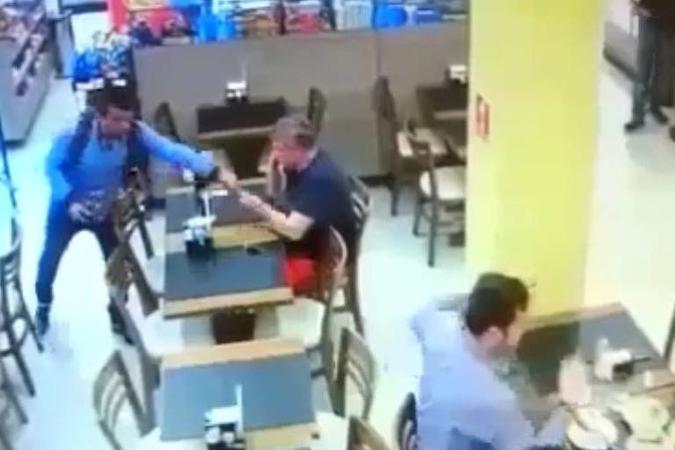 Ladrão pega celular de cliente durante roubo a padaria no Morumbi, em São Paulo (foto: Reprodução ) Ladrão pega celular de cliente durante roubo a padaria no Morumbi, em São Paulo (foto: Reprodução )