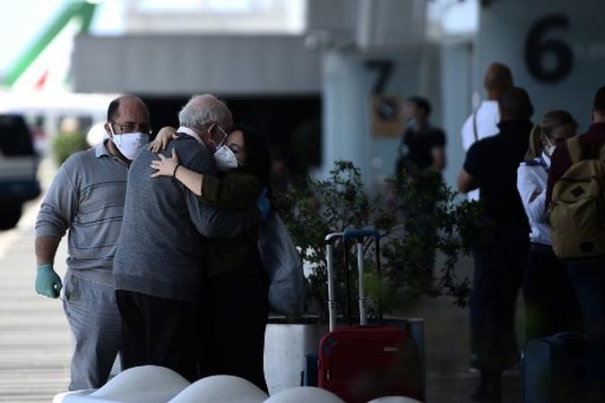 Os viajantes se abraçam no aeroporto de Fiumicino, em Roma, em 3 de junho de 2020, quando aeroportos e fronteiras reabrem para turistas e residentes livres para viajar pelo país, dentro da infecção por covid-19, causada pelo novo coronavírus.(foto: Filippo MONTEFORTE / AFP) Os viajantes se abraçam no aeroporto de Fiumicino, em Roma, em 3 de junho de 2020, quando aeroportos e fronteiras reabrem para turistas e residentes livres para viajar pelo país, dentro da infecção por covid-19, causada pelo novo coronavírus.(foto: Filippo MONTEFORTE / AFP)