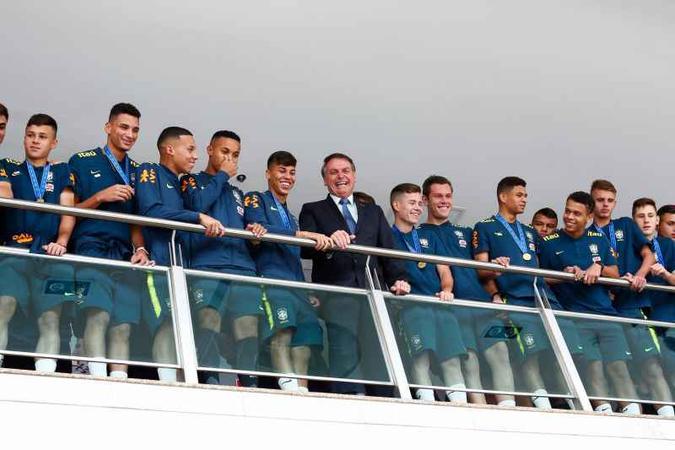 O presidente Jair Bolsonaro posou para fotos ao lado dos jovens tetracampeões(foto: Sérgio Lima/AFP ) O presidente Jair Bolsonaro posou para fotos ao lado dos jovens tetracampeões(foto: Sérgio Lima/AFP )